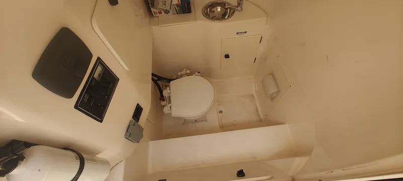 Slide: The Image of 2015 Pursuit S 280 Sport boat interior with toilet and sink. - 20