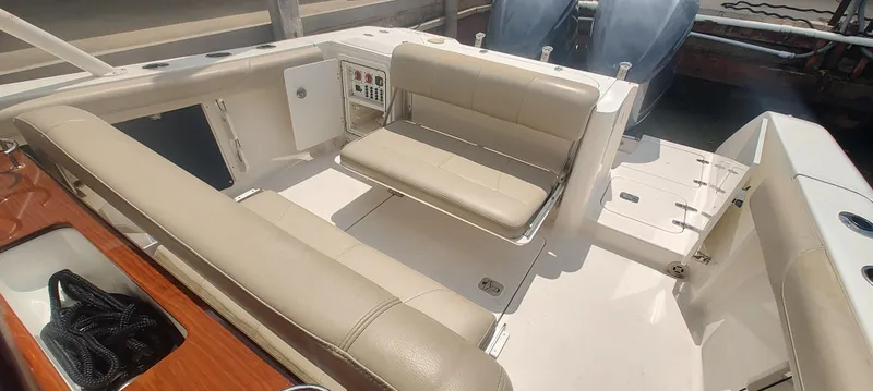 Slide: The Image of 2015 Pursuit S 280 Sport boat interior with beige seating and control panel. - 21