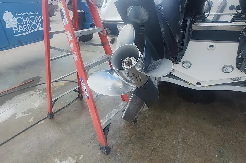 Slide: The Image of 2015 Pursuit S 280 Sport boat propeller near a red ladder at Michigan Harbor. - 24