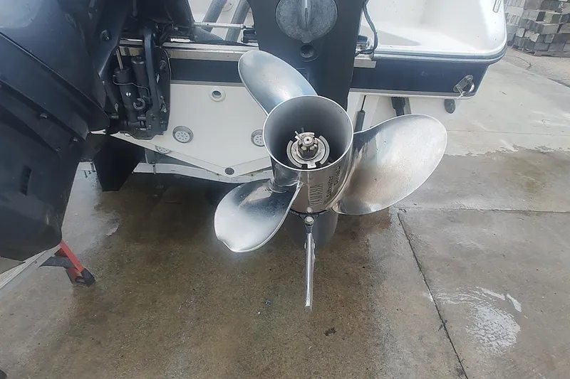 Slide: The Image of 2015 Pursuit S 280 Sport boat propeller on wet concrete surface. - 25