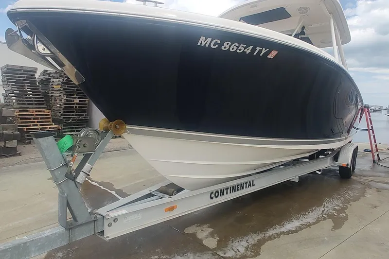 Slide: The Image of 2015 Pursuit S 280 Sport boat on trailer, dockside view. - 29