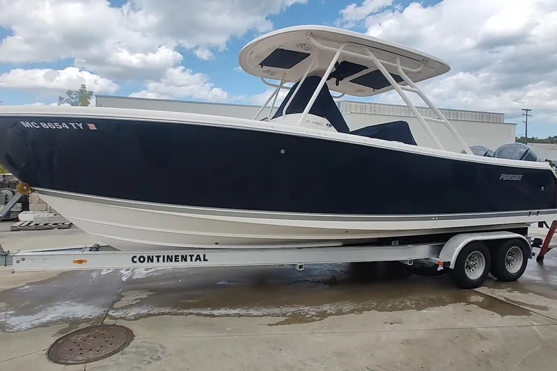 Slide: The Image of 2015 Pursuit S 280 Sport boat on a Continental trailer, parked outdoors. - 3