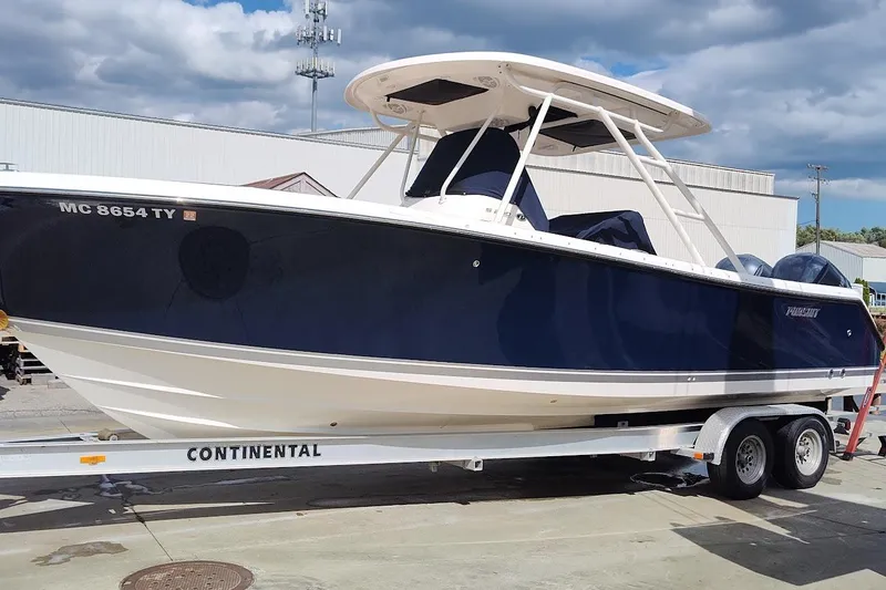 Slide: The Image of 2015 Pursuit S 280 Sport boat on trailer, parked outdoors under cloudy sky. - 36