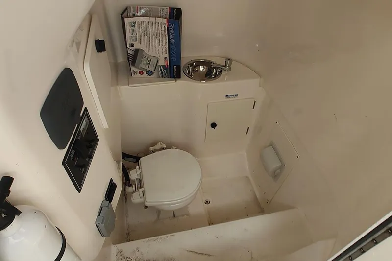 Slide: The Image of 2015 Pursuit S 280 Sport boat interior with toilet and sink. - 38