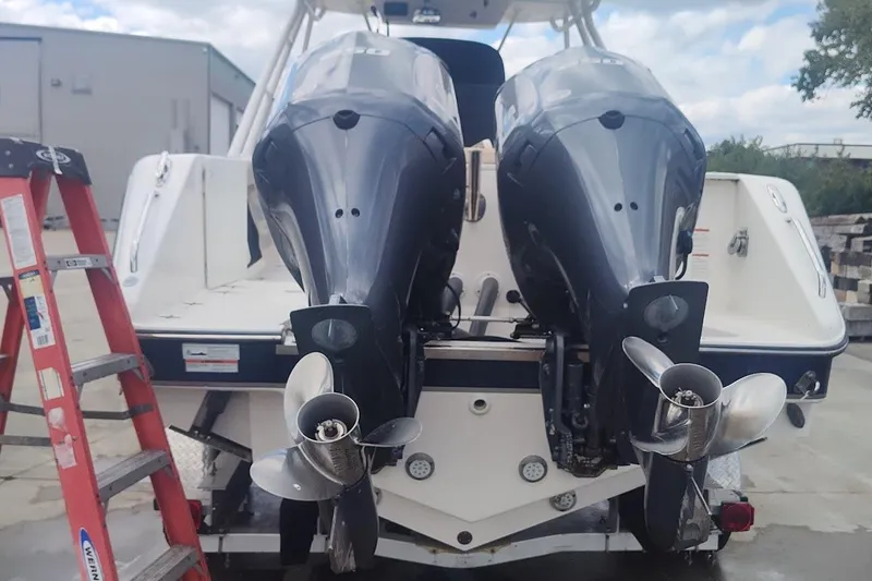 Slide: The Image of 2015 Pursuit S 280 Sport boat with dual outboard motors and a red ladder nearby. - 4