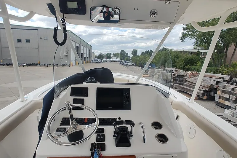 Slide: The Image of 2015 Pursuit S 280 Sport boat dashboard with steering wheel and navigation controls. - 41