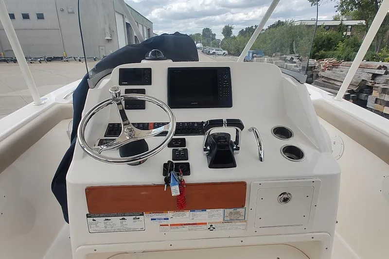Slide: The Image of Helm of 2015 Pursuit S 280 Sport boat with steering wheel and controls. - 42