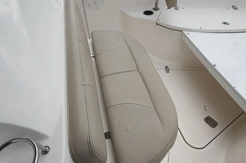Slide: The Image of 2015 Pursuit S 280 Sport boat interior with beige seating and white deck. - 43