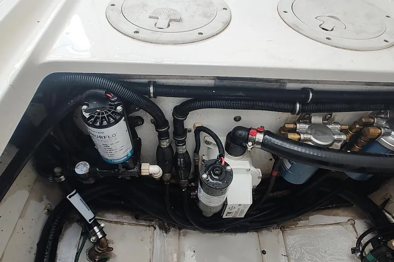 Slide: The Image of Engine compartment of a 2015 Pursuit S 280 Sport boat, showing hoses and filters. - 47