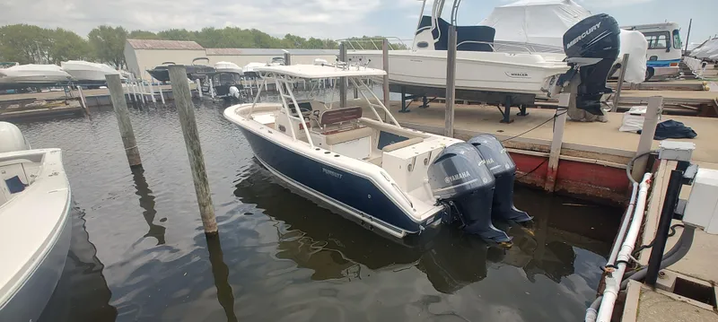 Slide: The Image of 2015 Pursuit S 280 Sport boat docked with twin outboard engines. - 5