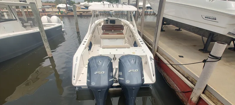 Slide: The Image of 2015 Pursuit S 280 Sport boat docked with twin 250 engines. - 8