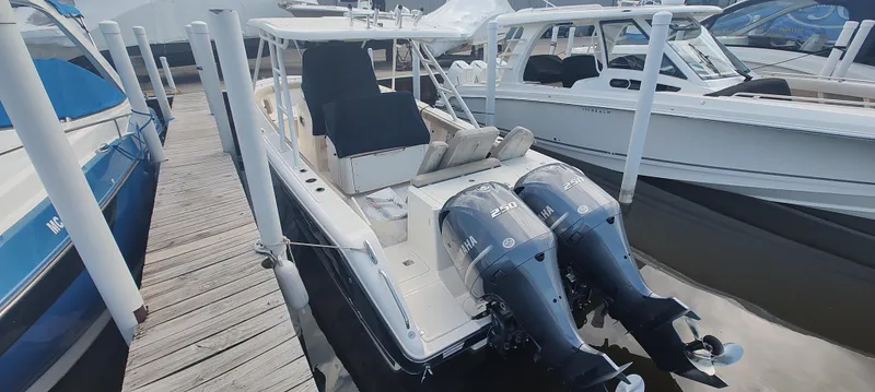 Slide: The Image of 2015 Pursuit S 280 Sport boat docked with twin outboard engines. - 9