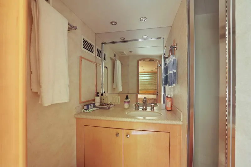 Slide: The Image of Luxurious bathroom interior of 2001 Hatteras 75 Sport Deck yacht with wooden cabinetry. - 31
