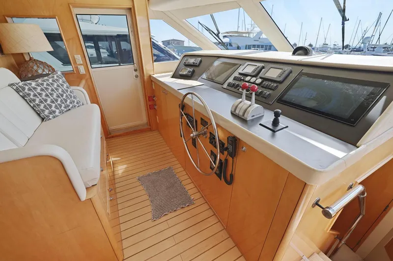 Slide: The Image of Helm of 2001 Hatteras 75 Sport Deck yacht with modern controls and wooden interior. - 39