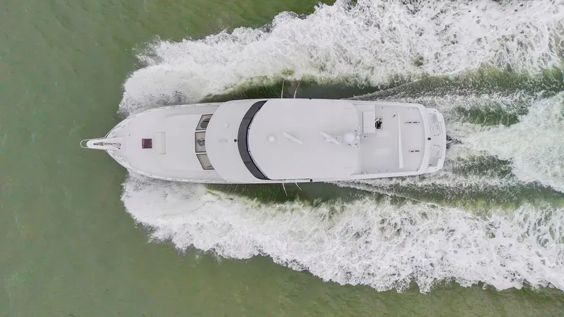 Slide: The Image of Aerial view of 2001 Hatteras 75 Sport Deck yacht cruising through water. - 7
