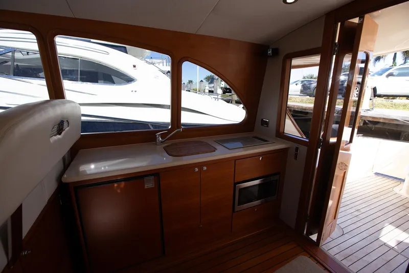 Slide: The Image of Interior of 2017 Palm Beach PB42 yacht with wooden cabinetry and modern kitchen amenities. - 16