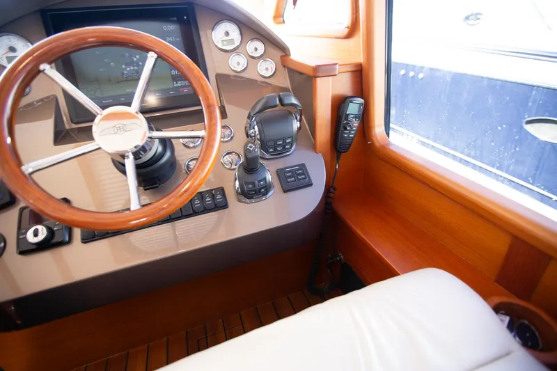 Slide: The Image of 2017 Palm Beach PB42 yacht helm with wooden steering wheel and modern controls. - 19