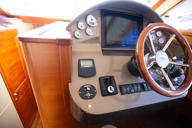 Slide: The Image of 2017 Palm Beach PB42 yacht helm with modern controls and wooden steering wheel. - 20