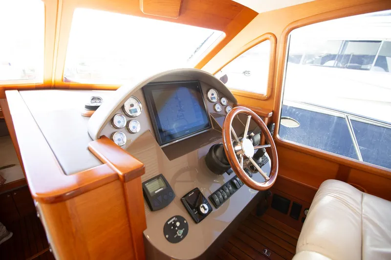 Slide: The Image of Luxurious 2017 Palm Beach PB42 yacht helm with wooden finish and modern controls. - 21