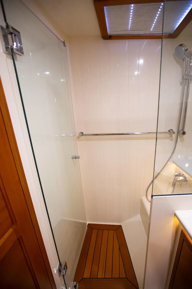 Slide: The Image of Luxurious 2017 Palm Beach PB42 yacht shower with glass door and wooden floor. - 23