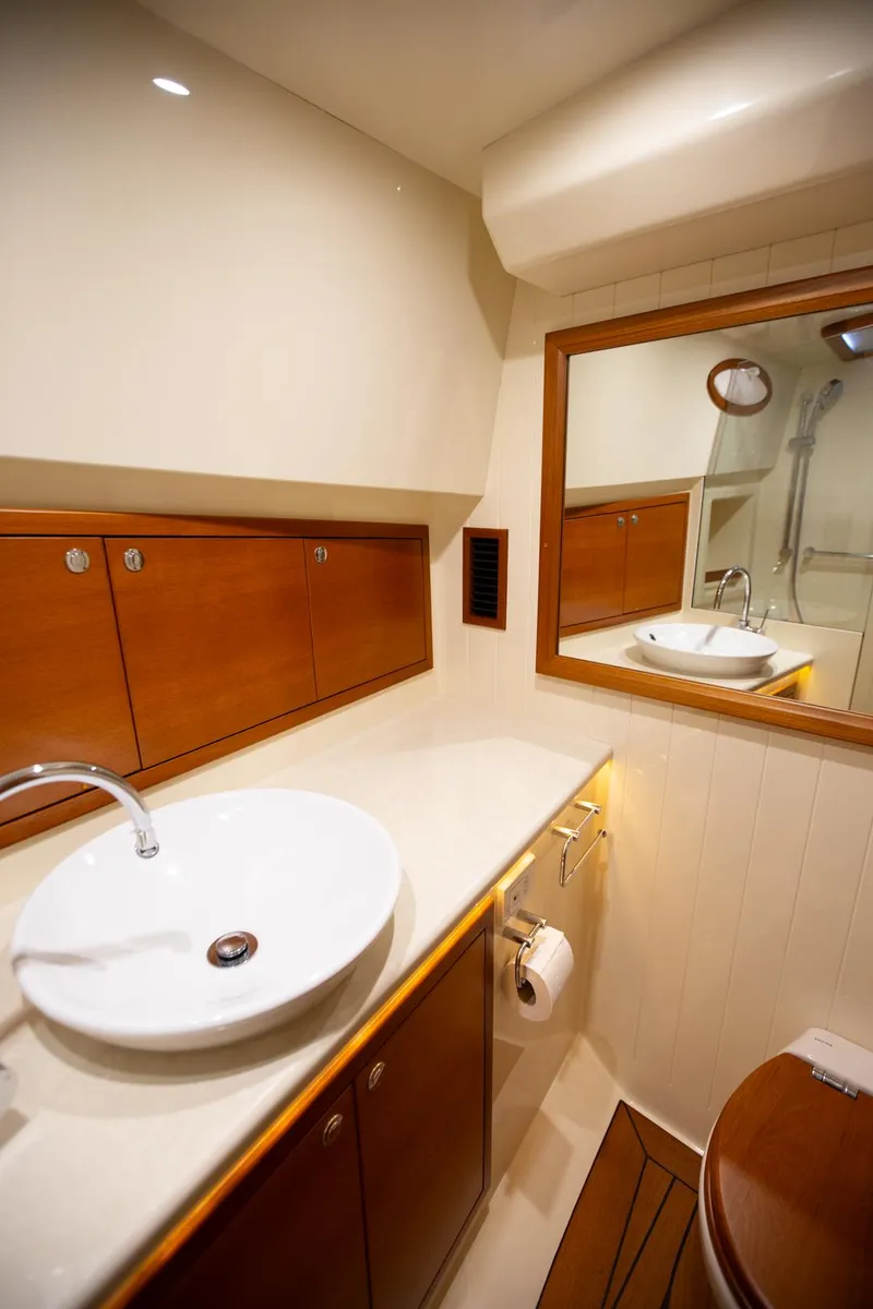Slide: The Image of Luxurious 2017 Palm Beach PB42 yacht bathroom with modern sink and wooden cabinetry. - 24
