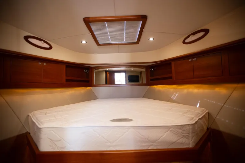 Slide: The Image of Luxurious 2017 Palm Beach PB42 yacht cabin with elegant wood finishes and cozy bedding. - 25