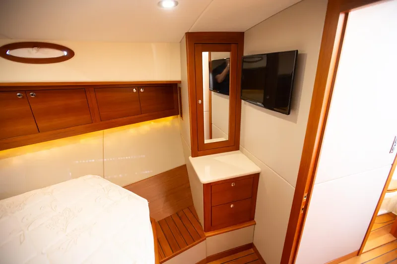 Slide: The Image of Luxurious 2017 Palm Beach PB42 yacht cabin with wood accents and modern amenities. - 26