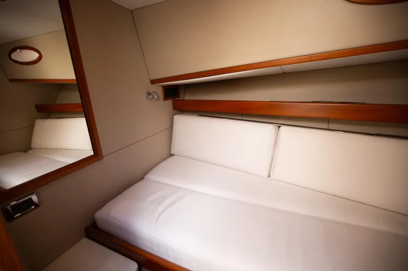 Slide: The Image of Luxurious cabin interior of 2017 Palm Beach PB42 yacht with white cushions and wooden accents. - 27