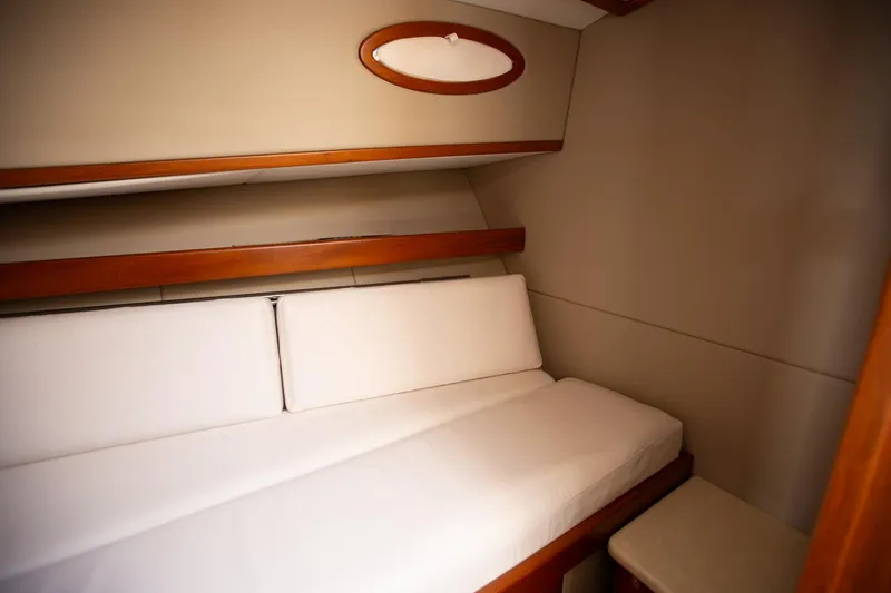 Slide: The Image of Cozy cabin interior of 2017 Palm Beach PB42 yacht with white bedding and wooden accents. - 28