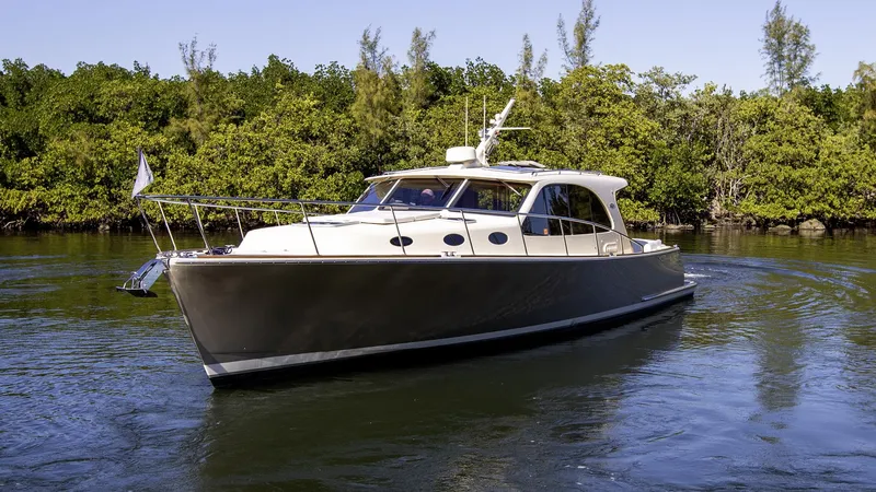 Slide: The Image of 2017 Palm Beach PB42 yacht cruising on a serene waterway. - 4