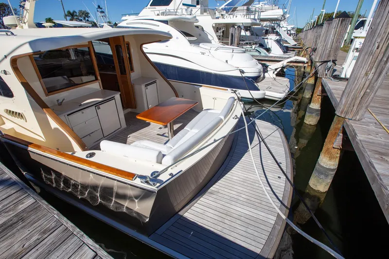 Slide: The Image of 2017 Palm Beach PB42 yacht docked at marina, featuring spacious deck and elegant design. - 7