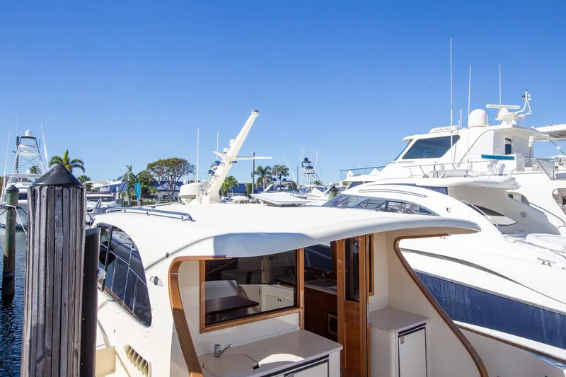 Slide: The Image of 2017 Palm Beach PB42 yacht docked at marina under clear blue sky. - 8