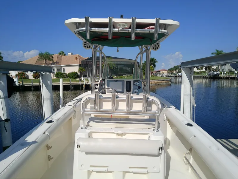 Slide: The Image of 2004 Trophy 2503 Center Console boat docked by waterfront homes. - 12