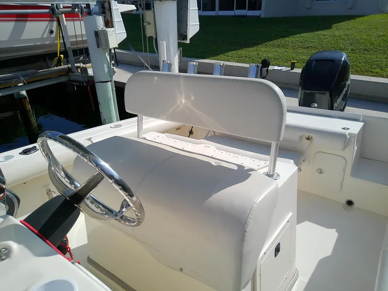 Slide: The Image of 2004 Trophy 2503 Center Console boat interior with steering wheel and seating. - 13
