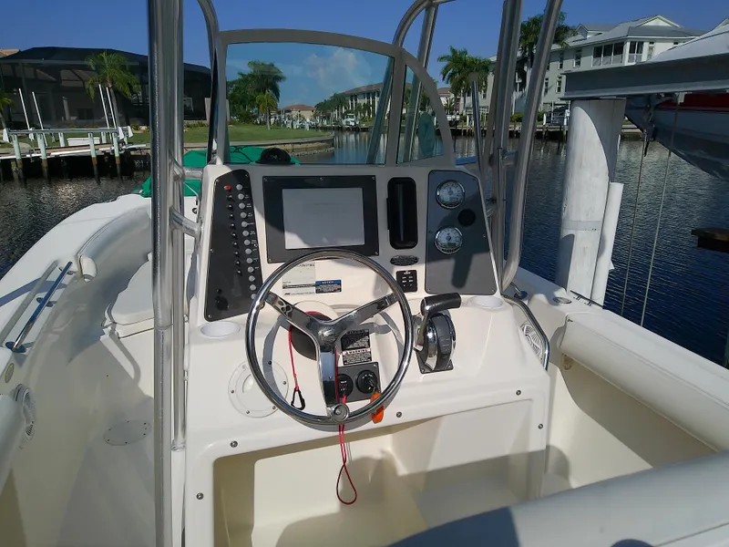 Slide: The Image of 2004 Trophy 2503 Center Console boat interior with steering wheel and control panel. - 14