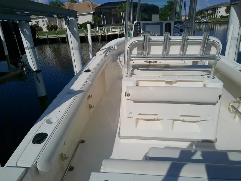 Slide: The Image of 2004 Trophy 2503 Center Console boat interior, docked by waterfront homes. - 15