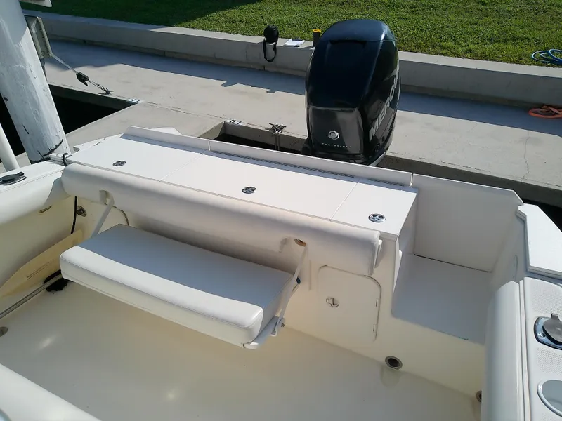 Slide: The Image of 2004 Trophy 2503 Center Console boat interior with seating and motor. - 18