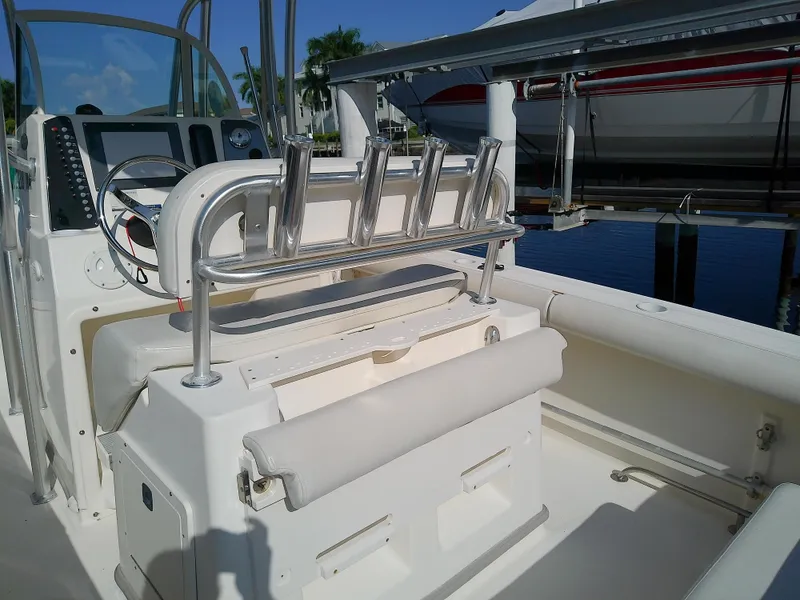 Slide: The Image of 2004 Trophy 2503 Center Console boat interior with rod holders and seating. - 19