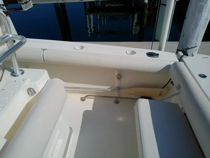 Slide: The Image of 2004 Trophy 2503 Center Console boat interior with seating and rod holders. - 21