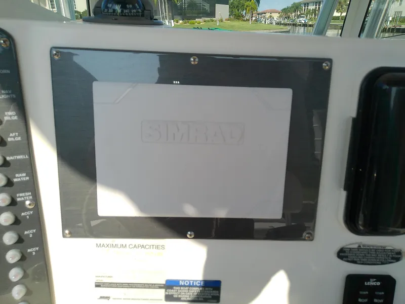 Slide: The Image of 2004 Trophy 2503 Center Console dashboard with Simrad display. - 23