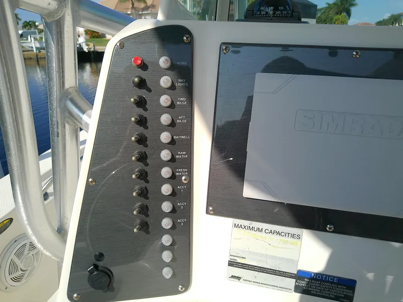 Slide: The Image of 2004 Trophy 2503 Center Console boat dashboard with control panel and display. - 28