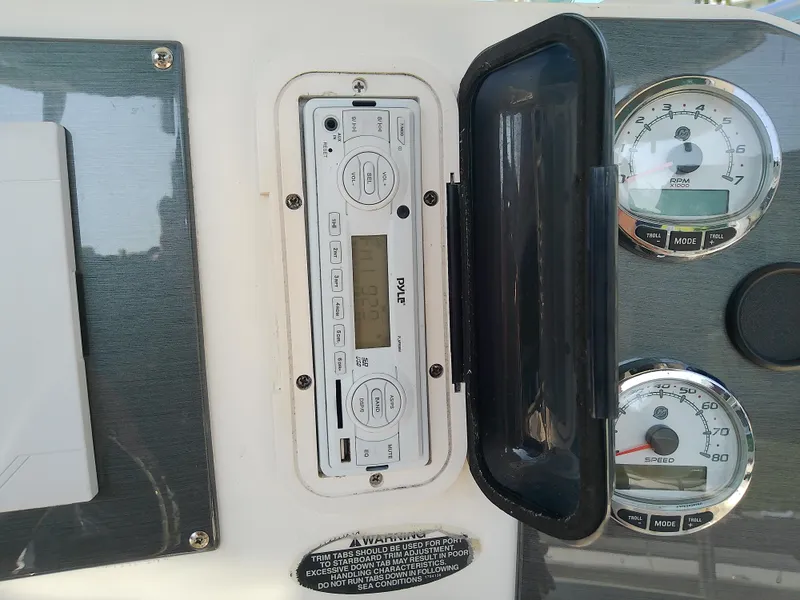 Slide: The Image of 2004 Trophy 2503 Center Console dashboard with stereo and gauges. - 29