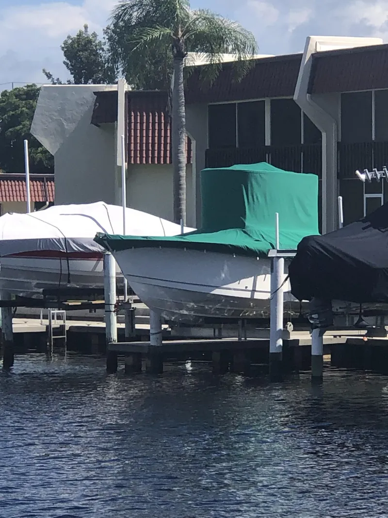 Slide: The Image of 2004 Trophy 2503 Center Console boat covered at a dockside marina. - 3