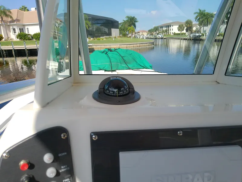 Slide: The Image of 2004 Trophy 2503 Center Console boat interior with compass, canal view. - 37