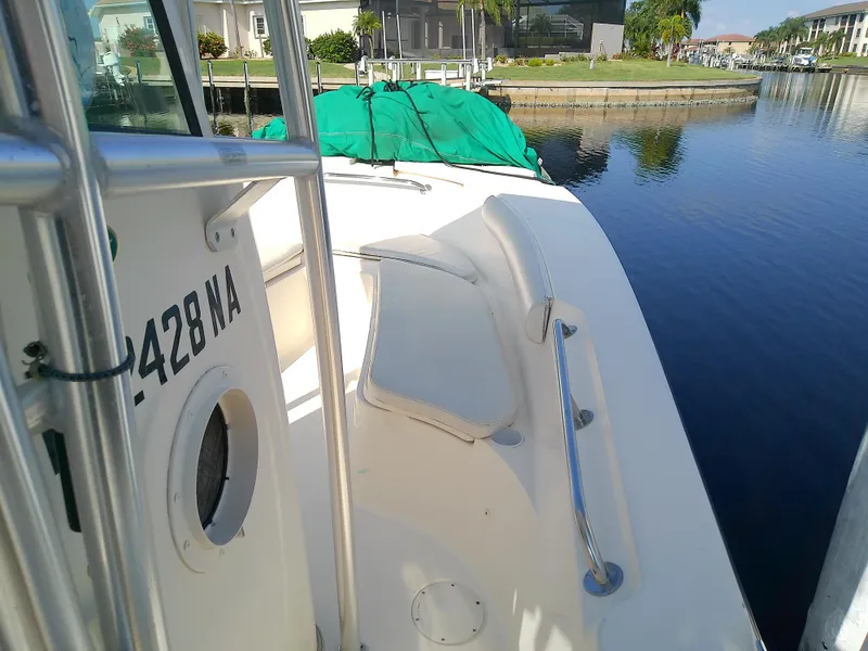 Slide: The Image of 2004 Trophy 2503 Center Console boat docked by calm waters. - 38