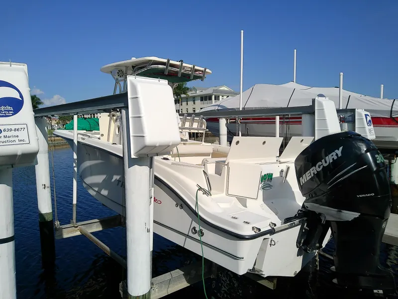 Slide: The Image of 2004 Trophy 2503 Center Console boat with Mercury engine docked at marina. - 4