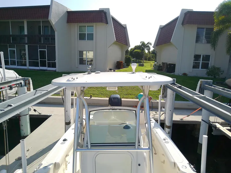 Slide: The Image of 2004 Trophy 2503 Center Console boat docked near residential buildings. - 41