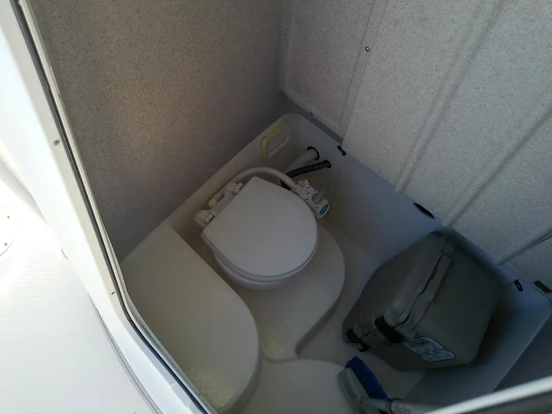 Slide: The Image of 2004 Trophy 2503 Center Console boat interior with compact marine toilet. - 45