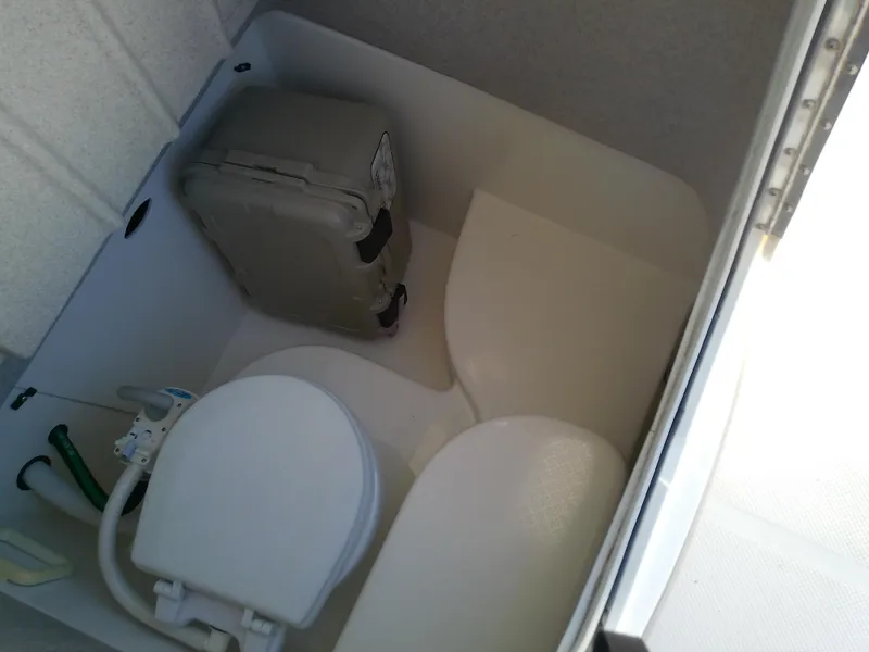 Slide: The Image of 2004 Trophy 2503 Center Console boat interior with portable toilet. - 46