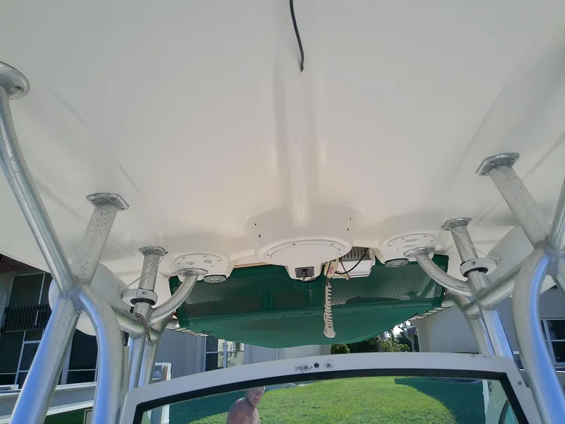 Slide: The Image of 2004 Trophy 2503 Center Console boat canopy and rod holders. - 47